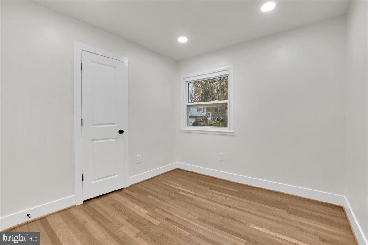 14624 Danville Road Woodbridge, VA 22193 - Photo 11 of 32 a view of an empty room with wooden floor and a window