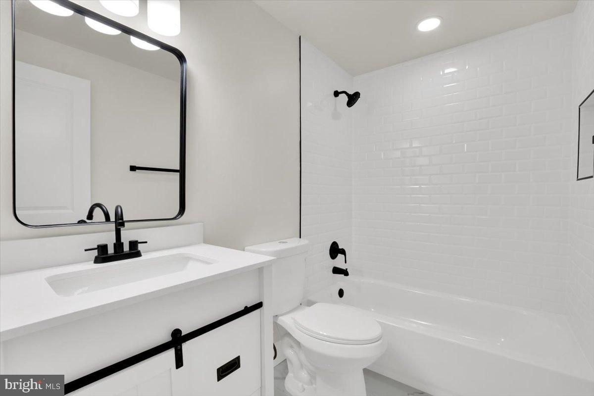 14624 Danville Road Woodbridge, VA 22193 - Photo 13 of 32 a bathroom with a sink a toilet and shower