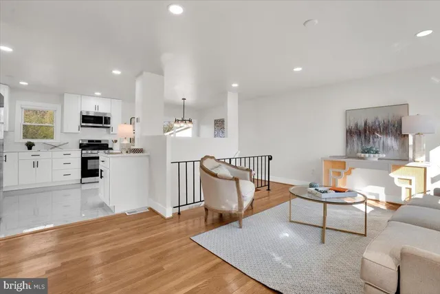 a living room with furniture and kitchen view