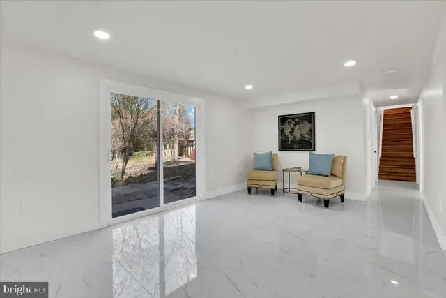 a living room with furniture and a floor to ceiling window
