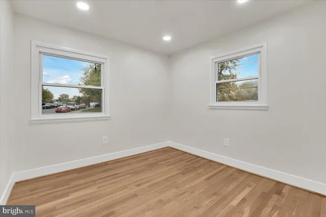 a view of room with window and wooden floor