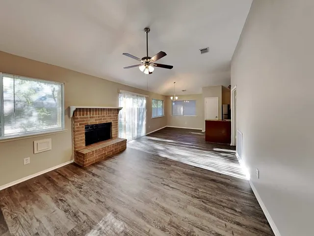 a view of fireplace with wooden floor fireplace and windows