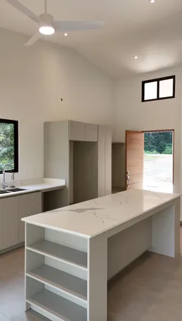 a kitchen with a stove and a hallway