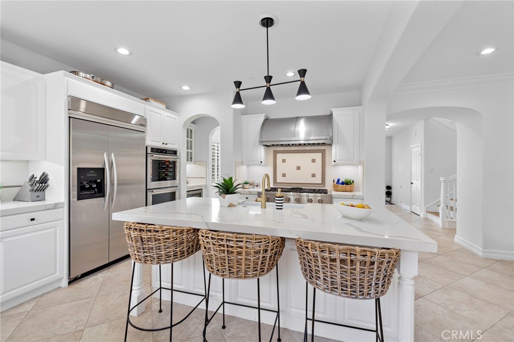 a kitchen with stainless steel appliances kitchen island granite countertop a kitchen island a sink and cabinets