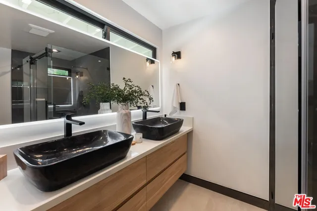 a living room with stainless steel appliances granite countertop a stove and a refrigerator
