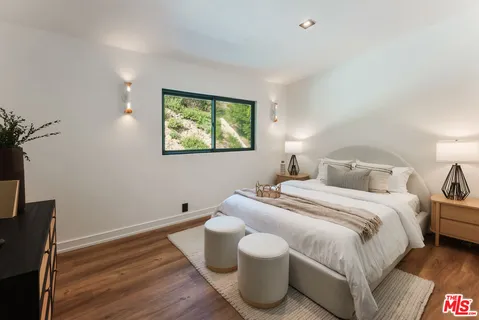 a bedroom with bed and a desk