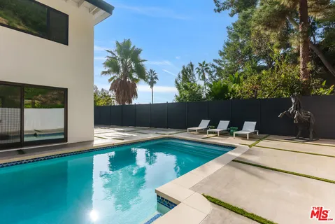 a view of swimming pool with chairs