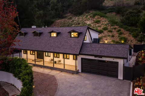 a aerial view of a house with a yard and garage