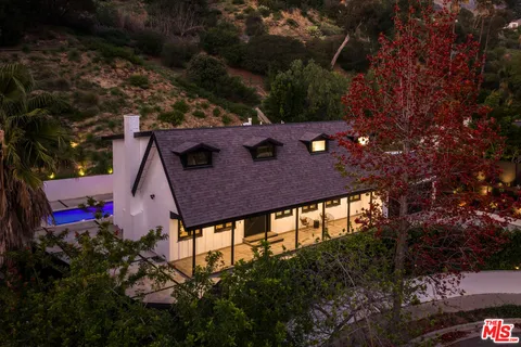 a view of a backyard with plants and a patio