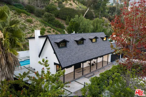 an aerial view of a house with yard and sitting area