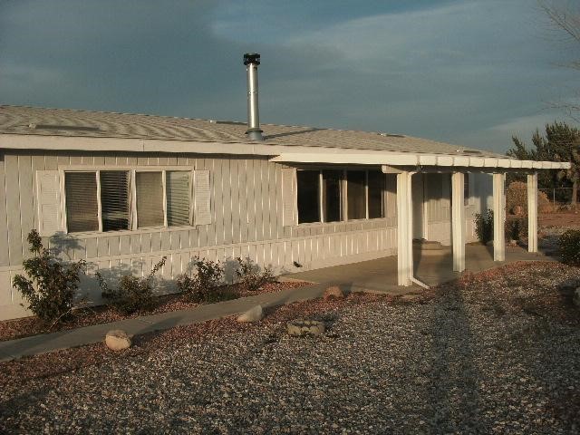 17226 Ranchero Road Hesperia, CA 92345 - Photo 1 of 1 a front view of a house with garden