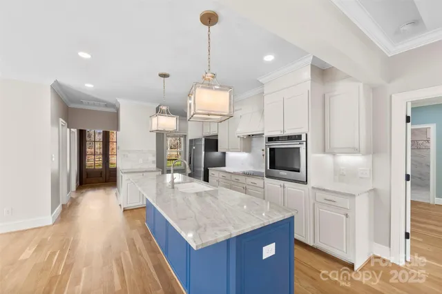 a kitchen with granite countertop counter top space a sink stainless steel appliances and cabinets