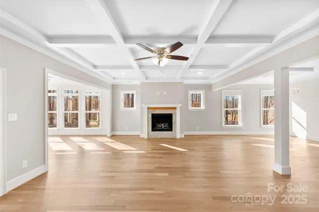 a view of an empty room with a fireplace and a window