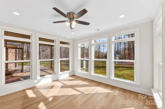 a view of a livingroom with a ceiling fan and window