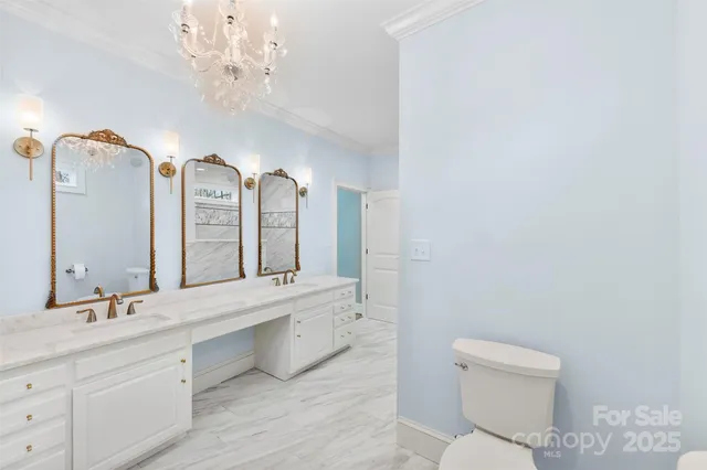 a spacious bathroom with a double vanity sink toilet and a mirror
