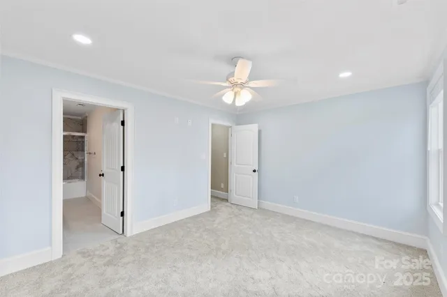 a bathroom with a bathtub shower sink vanity mirror and toilet