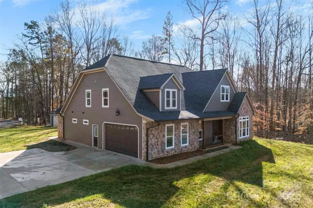 a front view of a house with a yard table and chairs