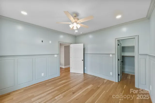 a view of an empty room and window and wooden floor