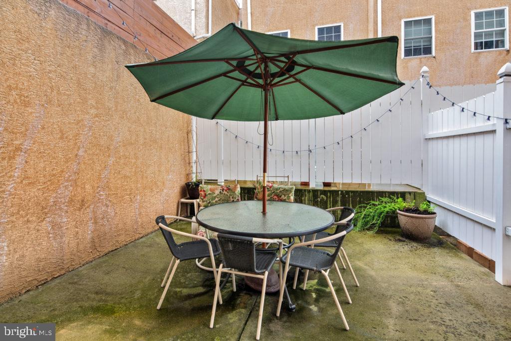 2614 Webster Street, Unit A Philadelphia, PA 19146 - Photo 11 of 12 a patio table and chairs under an umbrella