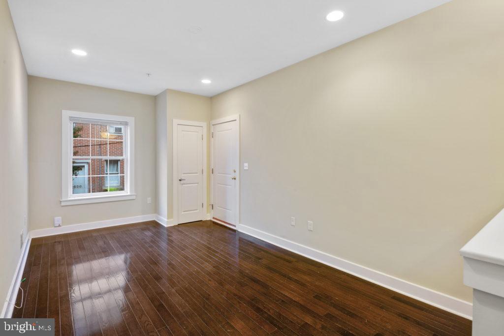 2614 Webster Street, Unit A Philadelphia, PA 19146 - Photo 4 of 12 an empty room with wooden floor and windows