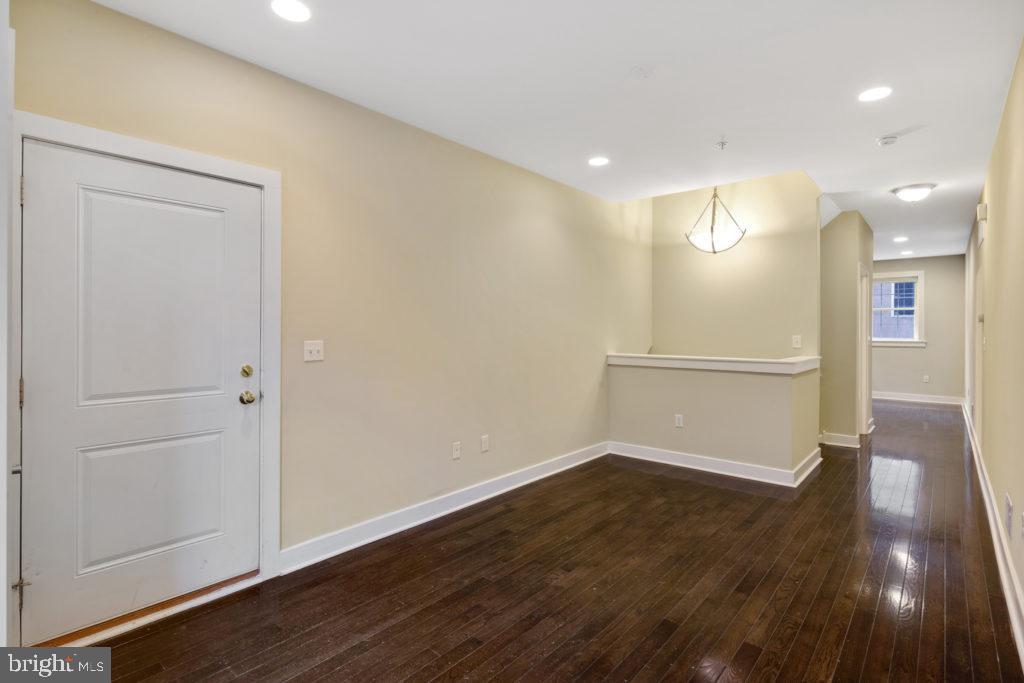 2614 Webster Street, Unit A Philadelphia, PA 19146 - Photo 5 of 12 an empty room with wooden floor and windows