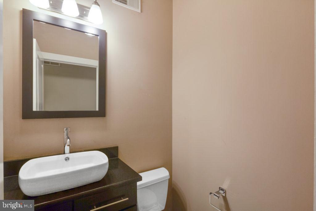 2614 Webster Street, Unit A Philadelphia, PA 19146 - Photo 6 of 12 a bathroom with a toilet a sink and mirror