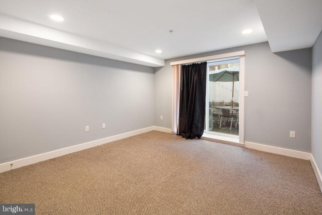 2614 Webster Street, Unit A Philadelphia, PA 19146 - Photo 8 of 12 an empty room with floor to ceiling window and an empty room