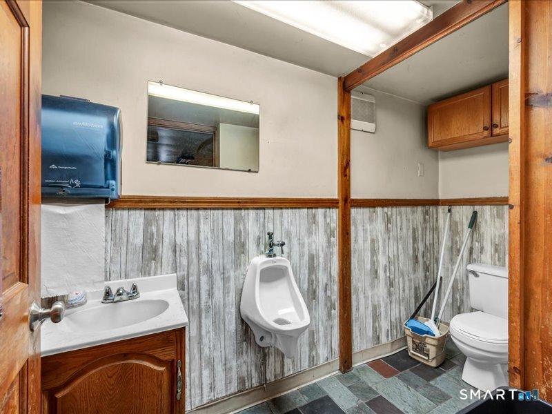 61 Maple Avenue Wallingford, CT 06492 - Photo 9 of 20 a bathroom with a toilet a sink and mirror