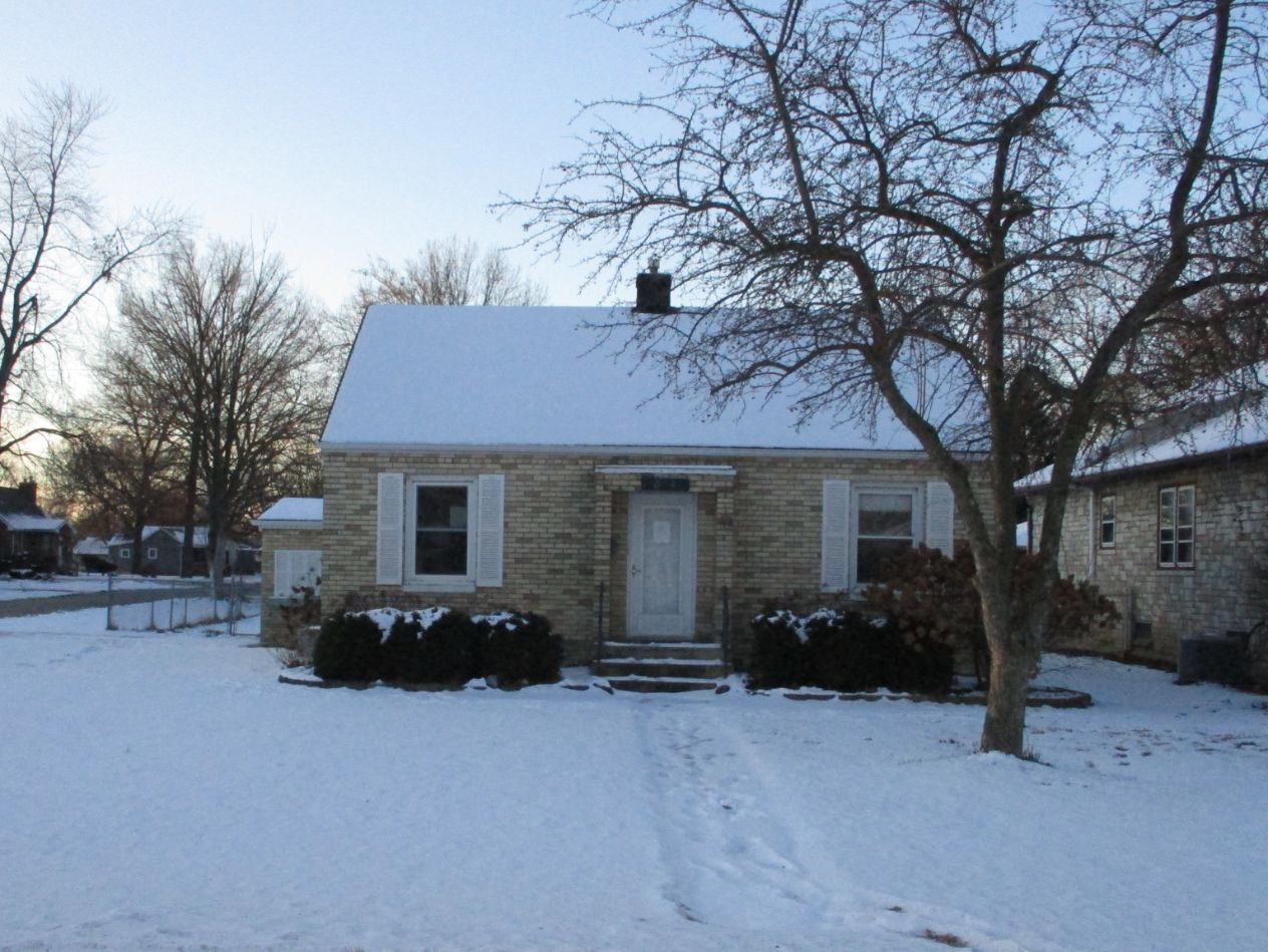 a view of a house with a yard covered with snow in front of house