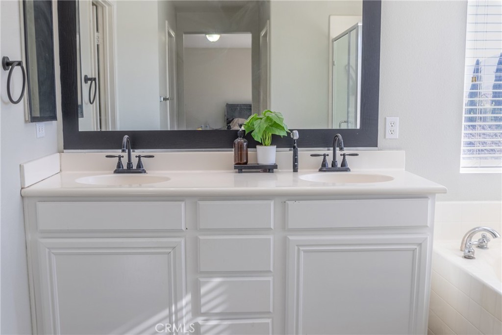 1639 Rigel Street Beaumont, CA 92223 - Photo 11 of 16 a bathroom with a sink vanity and a mirror