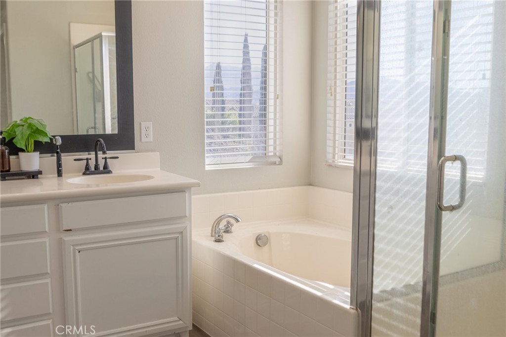 1639 Rigel Street Beaumont, CA 92223 - Photo 12 of 16 a bathroom with a bathtub and a sink
