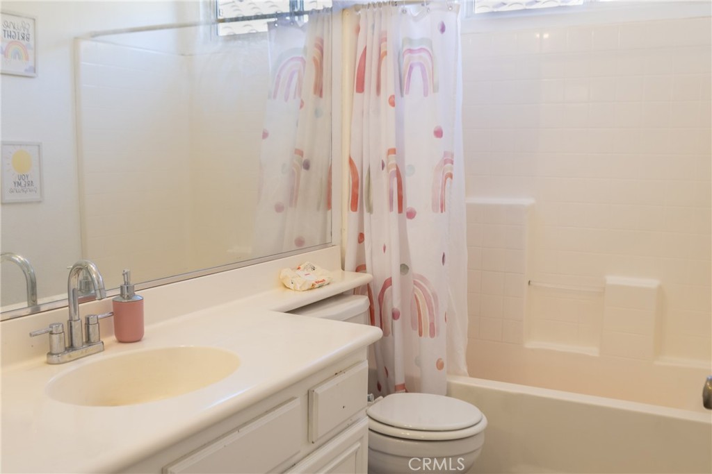 1639 Rigel Street Beaumont, CA 92223 - Photo 13 of 16 a bathroom with a sink a toilet and shower