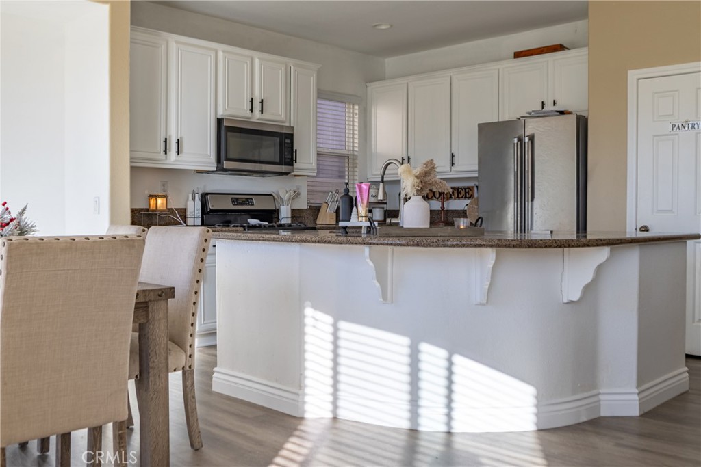 1639 Rigel Street Beaumont, CA 92223 - Photo 4 of 16 a kitchen with stainless steel appliances granite countertop a refrigerator microwave and sink