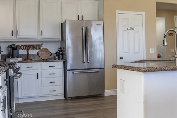 a view of kitchen with furniture and wooden floor