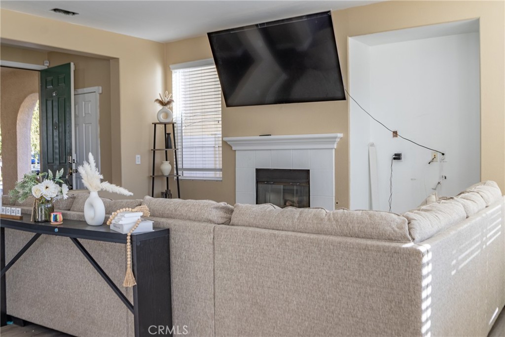 1639 Rigel Street Beaumont, CA 92223 - Photo 7 of 16 a living room with furniture and a fireplace