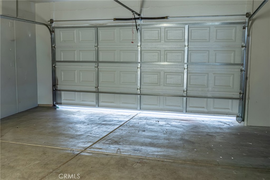 1639 Rigel Street Beaumont, CA 92223 - Photo 8 of 16 a view of an empty room with wooden floor and cabinet