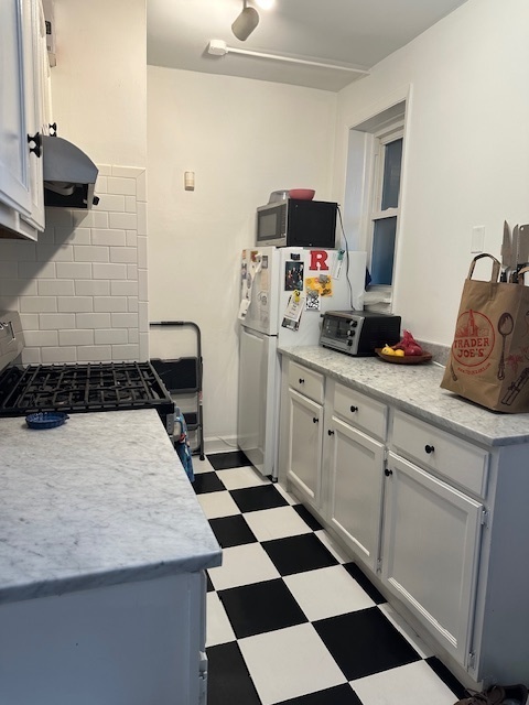 1459 West Elmdale Avenue, Unit 3 Chicago, IL 60660 - Photo 12 of 13 a kitchen with a sink and a stove top oven