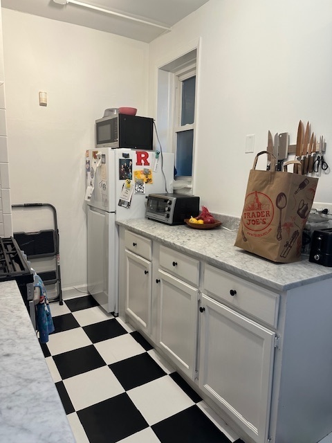 1459 West Elmdale Avenue, Unit 3 Chicago, IL 60660 - Photo 9 of 13 a kitchen with a sink and a stove top oven