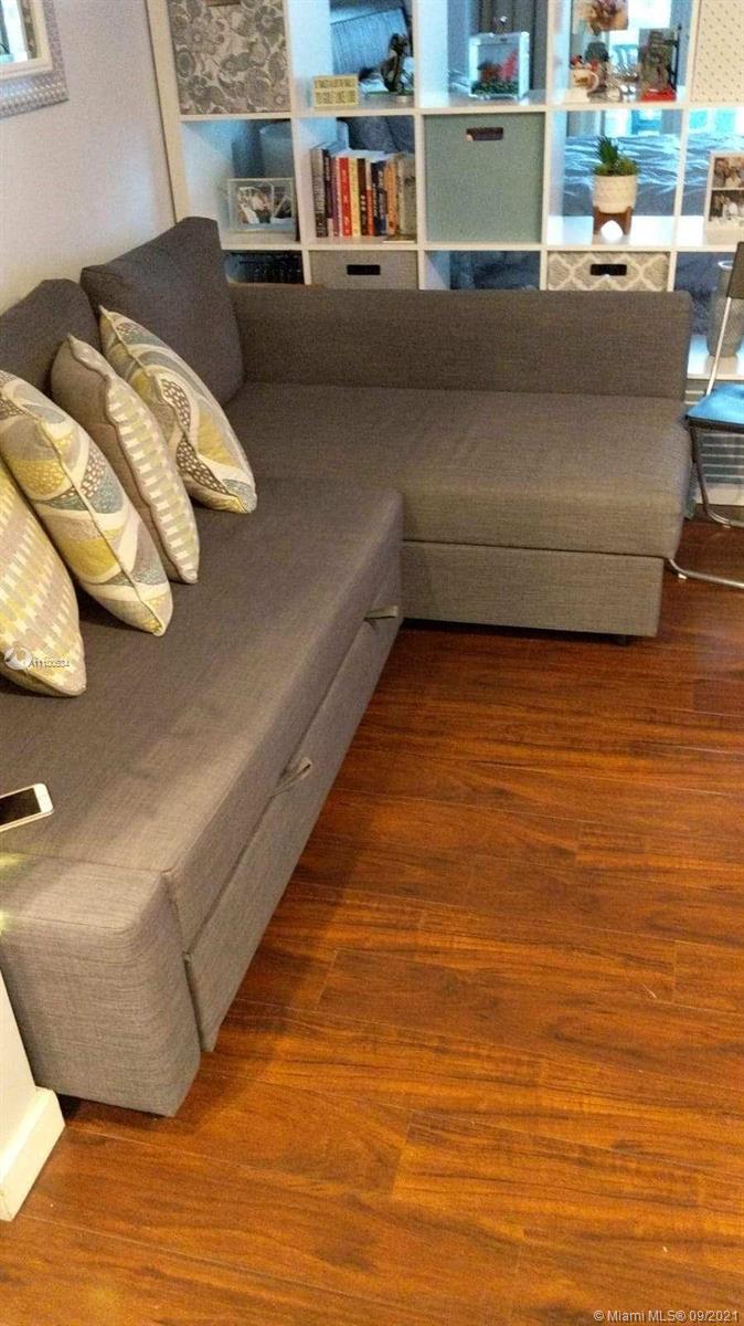 2889 McFarlane Road, Unit 1603 Miami, FL 33133 - Photo 10 of 16 a living room with a couch