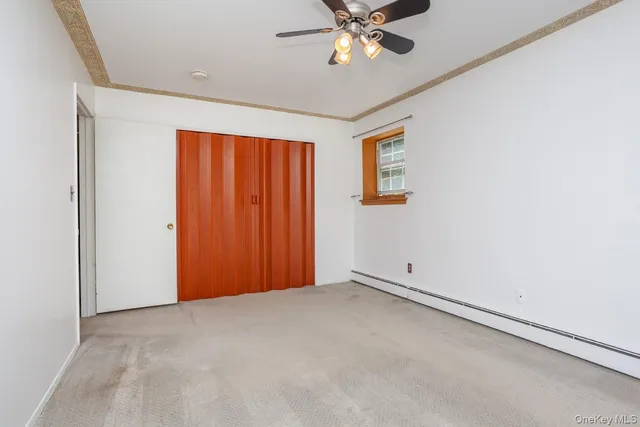an empty room with a chandelier fan