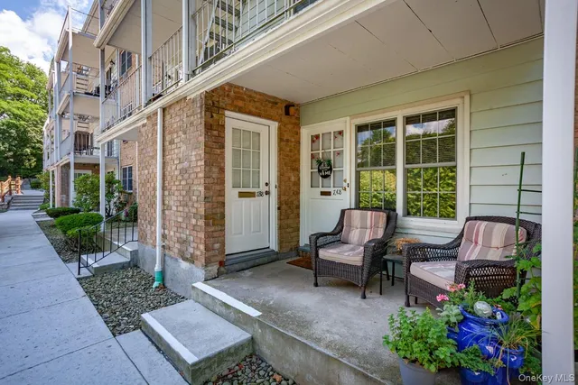 a view of a patio with chair and tables back yard of the house