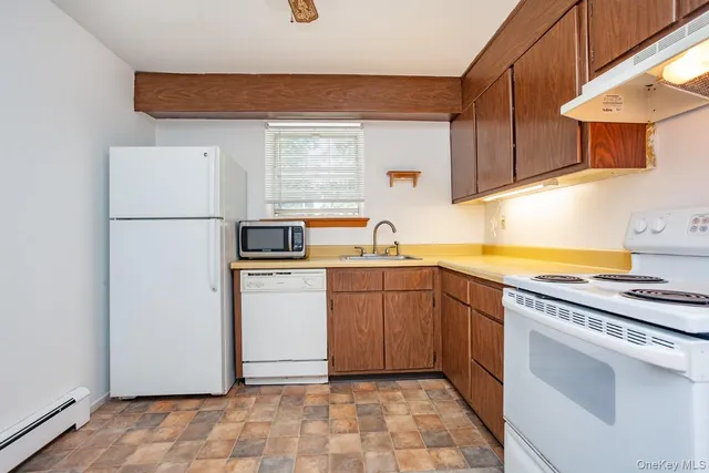 a kitchen with a refrigerator sink and cabinets