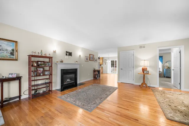 a view of a livingroom with a fireplace cabinet and window