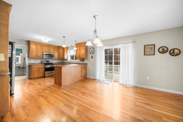 a large kitchen with stainless steel appliances granite countertop a stove and a refrigerator