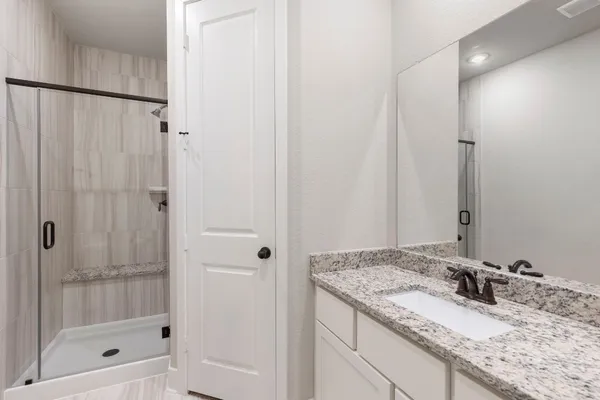 a bathroom with a sink vanity and a mirror
