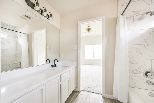 a bathroom with a double vanity sink and a mirror