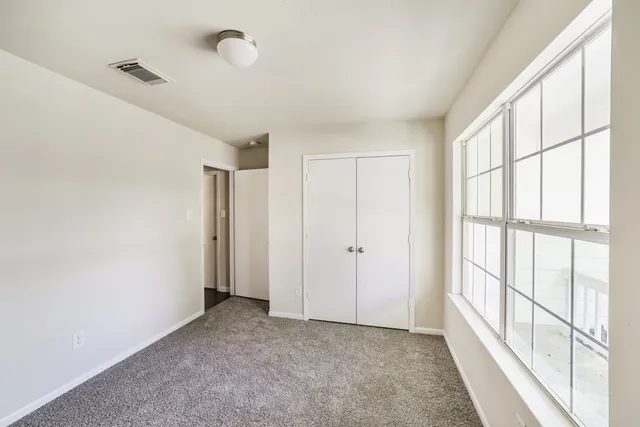 a view of hallway with windows