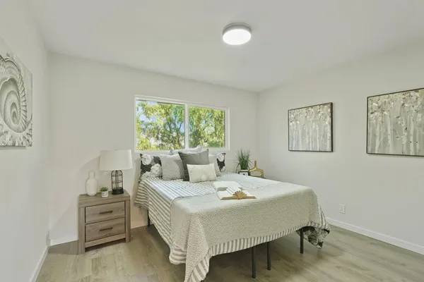 a bedroom with a bed and a window