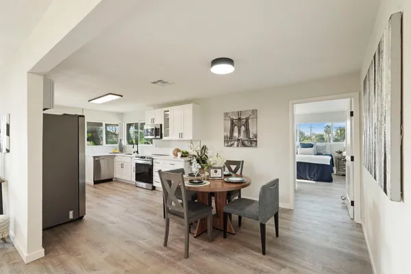 a view of a dining room with furniture and wooden floor