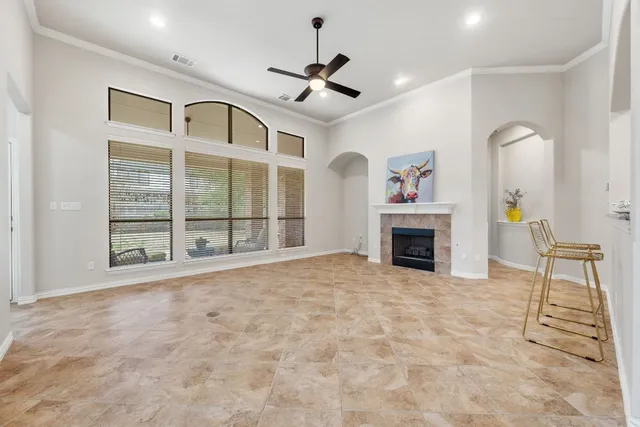 a view of an empty room with a fireplace and a window